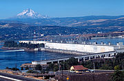 Looking west, fish ladder in the foreground, power generation center. Mount Hood rises in the background.