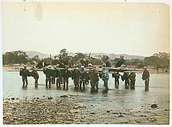Porters at a ford on the Sakawa River, near Odawara
