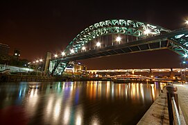 A night view of the Tyne Bridge taken from the northern embankment, looking west