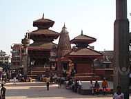 Near the palace of the Malla dynasty rulers in Lalitpur with pillar and statue of king Yoga Narendra Malla (Lalitpur).