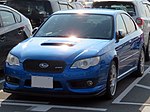 Subaru Legacy S402 sedan, a high-performance variant of the standard Subaru Legacy sedan. This photo shows the front of the car, which is blue; there is a "S402" badge on the front grille.