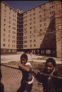 Two black children in front of a residential building at the Stateway Gardens housing project