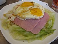 Ham and eggs over rice and served with lettuce