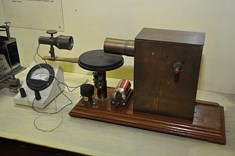 Jagadish Chandra Bose in 1894 was the first person to produce millimeter waves; his spark oscillator (in box, right) generated 60 GHz (5 mm) waves using 3 mm metal ball resonators.