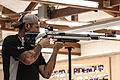 Competitor taking aim through a diopter and globe sighting line on a Feinwerkbau P700 PCP target air rifle at the 2014 Warrior Games.