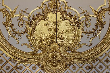 Rococo cartouche with putti in the Cabinet de la Pendule, Palace of Versailles, France, created and sculpted by Jacques Verberckt,1738[11]