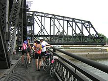 Cyclists on the bridge, waiting for it to close