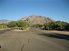 Mountains rise in the background of a photo from a residential area in Oro Valley.