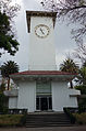 Picture of a clock tower whose clock reads 4:57 in the afternoon.