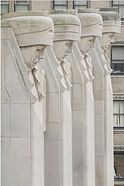 Stone statues on the facade of 20 Exchange Place, as seen from the side