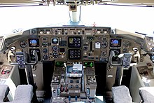 View of a 757 cockpit with six paired color displays.
