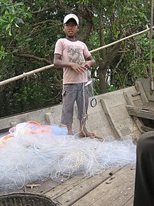 Child fishing in Tonlé Sap, Cambodia