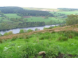 A lake in a valley surrounded by steep slopes