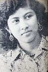 A black and white portrait of a young woman.