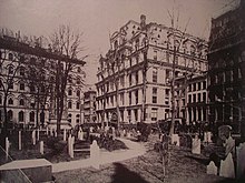 Photograph looking northeast from Trinity churchyard across Broadway, at the Equitable Life Assurance Building in 1870
