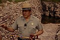 An NPS ranger holding a pipe at the quarry