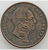 Copper coin with a man's head and letters stamped on it