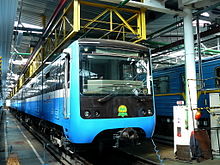 Blue mass-transit train pulling into a station
