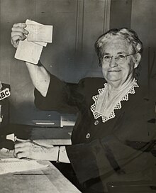 Edith holds up her Communist Party Membership Card during her testimony before the HUAC on March 28, 1953.