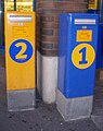 Post boxes in Heinola, Finland. Yellow 2nd class postbox is very common, blue 1st class mailboxes only at selected places.