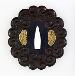 Japanese volutes on a tsuba, unknown date, shakudo and gold, Walters Art Museum