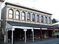Shop facades next to Bank of New Zealand Building, 19th Century