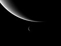 Photograph of the planet Neptune (large, background) and its moon Triton (small, foreground), taken by Voyager 2 as it entered the outer Solar System