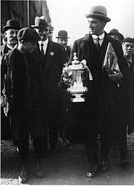 Image on Tottenham High Road in 1921, with captain Arthur Grimsdell holding the FA cup surrounded by fans