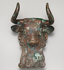 a bronze bull's head in a museum