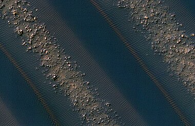 Close-up view of dunes in previous image, as seen by HiRISE. Note how sand barely covers some boulders.