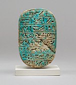 The back of a commemorative scarab of Amenhotep III, recording a lion hunt; 1390–1352 BC; blue glazed steatite; length: 8 cm; Metropolitan Museum of Art