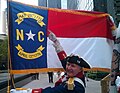 A Mecklenburg Declaration reenactor points to the May 20th, 1775 date on the North Carolina State Flag at the May 20, 2011 commemoration ceremony.