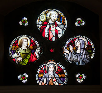 Stained glass depicting the Sacred Heart (top), John the Evangelist (left), Marguerite Marie Alacoque (right), and Gertrude the Great (bottom).