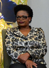 A woman with glasses, Beatrice Mtetwa, sitting in a chair