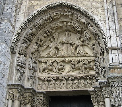 West portal, tympanum of left door. It depicts Christ on a cloud, supported by two angels, above a row of figures representing the labours of the months and signs of the Zodiac[34]