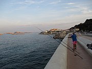 Fishermen on the Corniche with the Frioul archipelago in the distance