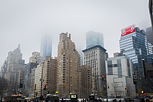 View of 240 Central Park South from across Columbus Circle on a foggy day
