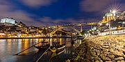 Night view of the bridge showing the historic centre of Porto and main archway