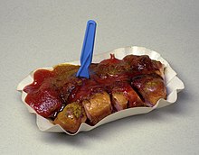 Currywurst, Berliner style. The red sauce is curry ketchup with additional curry powder sprinkled on top.