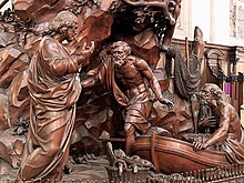 depiction of a life size wooden carving of Jesus calling Peter and Andrew as they climb out of their fishing boat