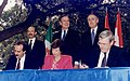 Image 24Three world leaders: (background, left to right) Mexican President Carlos Salinas de Gortari, U.S. President George H. W. Bush, and Canadian Prime Minister Brian Mulroney, observe the signing of the North American Free Trade Agreement. (from History of Mexico)