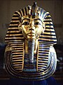 Tutankhamun's mask - King Tutankhamun, son of Akhenaten, returned to the former capitol and restored the cult of Amun to its former influence; although he died young and was not considered significant in his own time, the 1922 discovery of his KV62 intact tomb by Howard Carter, made him relevant as a symbol of ancient Egypt to the modern world