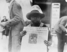 A boy selling The Washington Daily News - sign on his hat reads, "Have you read The News? One cent" - headline reads "Millionaire tax rends G.O.P."