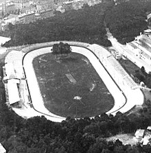 Monochrome aerial photograph of the Vélodrome de Vincennes. The stadium is oval in shape with a central grassed area.