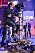 A camera dolly on steel tracks during a conference