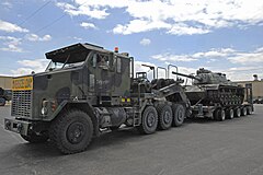 Am Oshkosh M1070A0 HET and a DRS M1000 semi-trailer hauling an M60 Patton tank