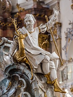 St Eustace holding a stag with a crucifix between its antlers