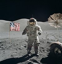 A man standing on the moon with an American flag in the background