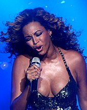 Beyoncé performing with an emotional facial expression