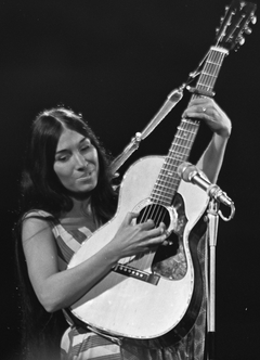 A young woman playing a classical guitar